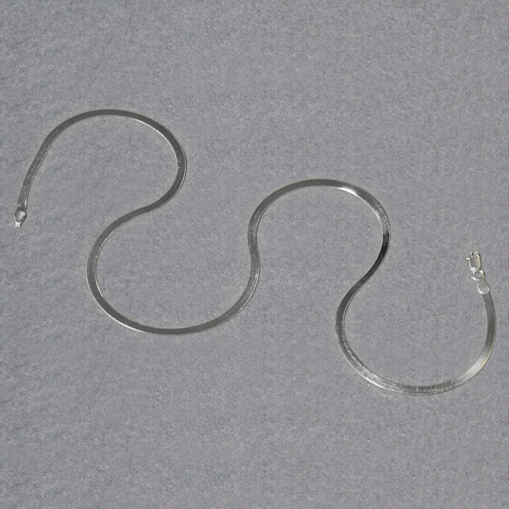 Herringbone chain in 14K white gold laid out in loops