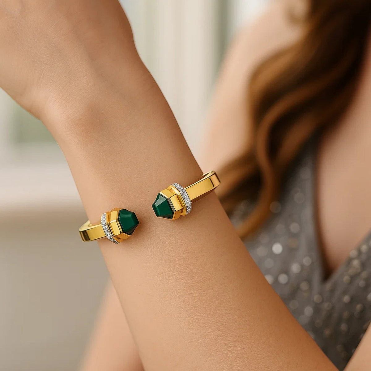 Malachite open cuff in 14K yellow gold worn on the wrist