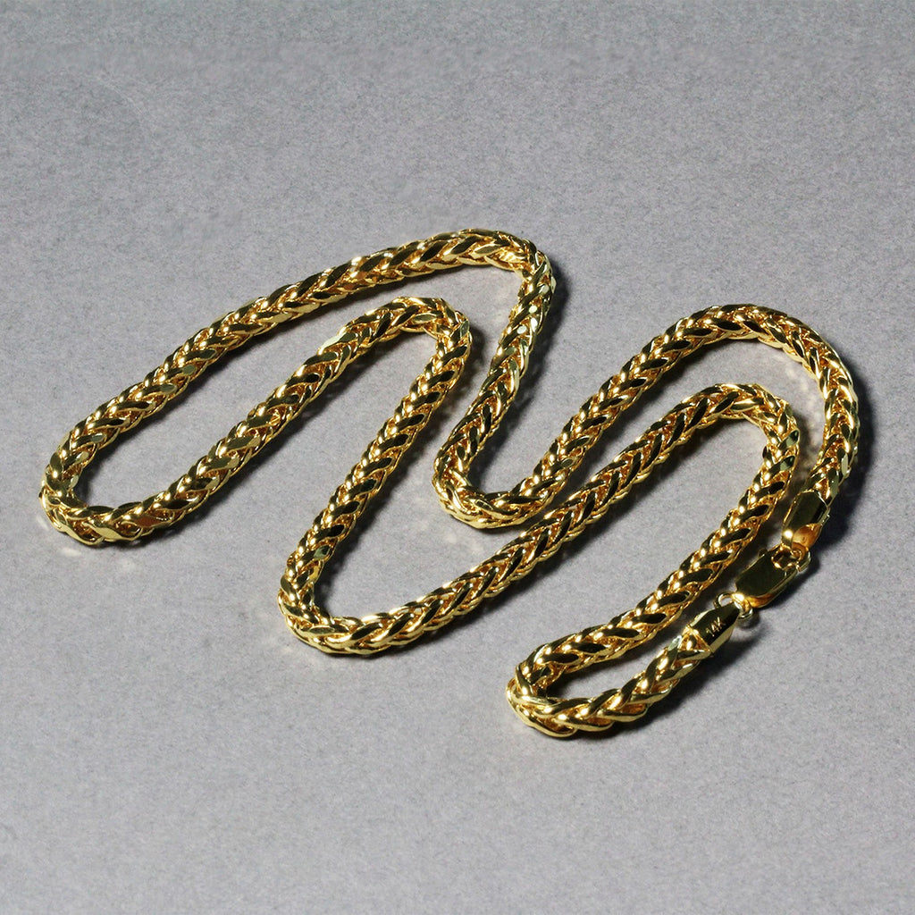 Diamond-cut Franco chain in 14K yellow gold laid out in loops