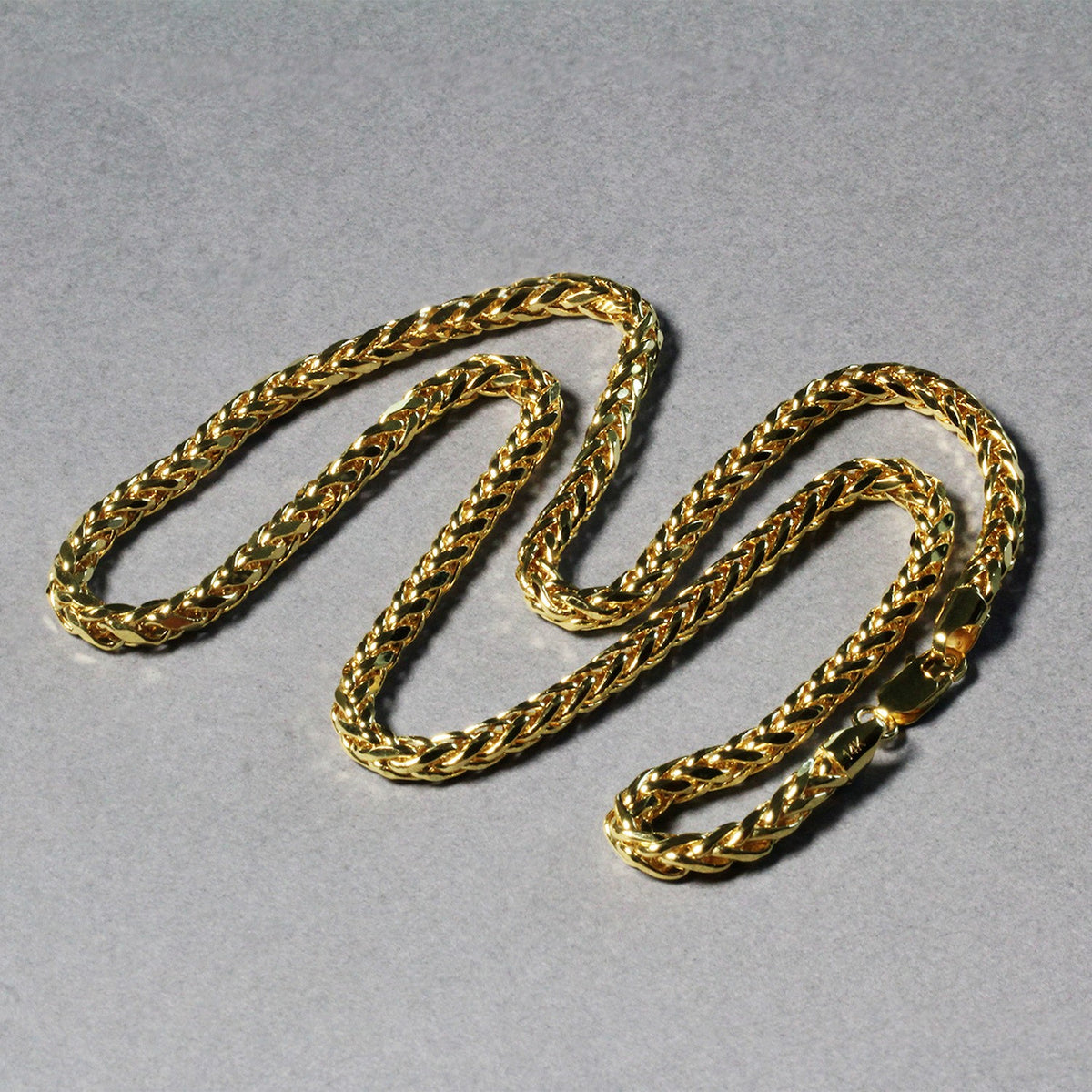 Diamond-cut Franco chain in 14K yellow gold laid out in loops