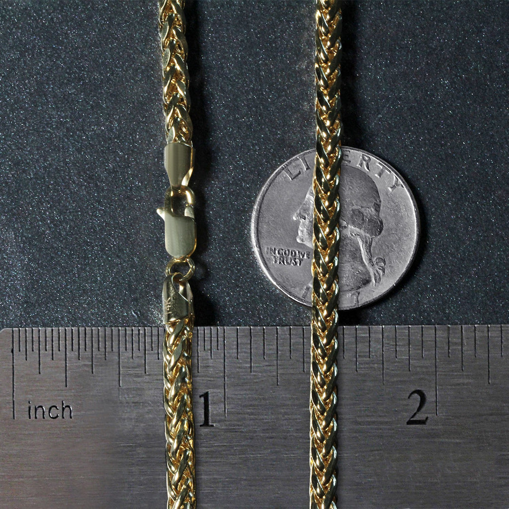4.1mm Franco chain in 14K yellow gold beside an inch ruler and a coin for scale