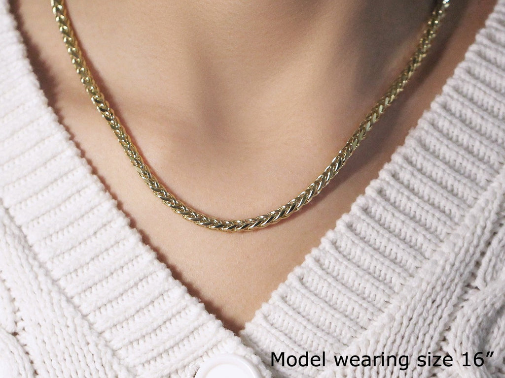Franco chain in 14K yellow gold worn close to the neck, photographed at 16 inches