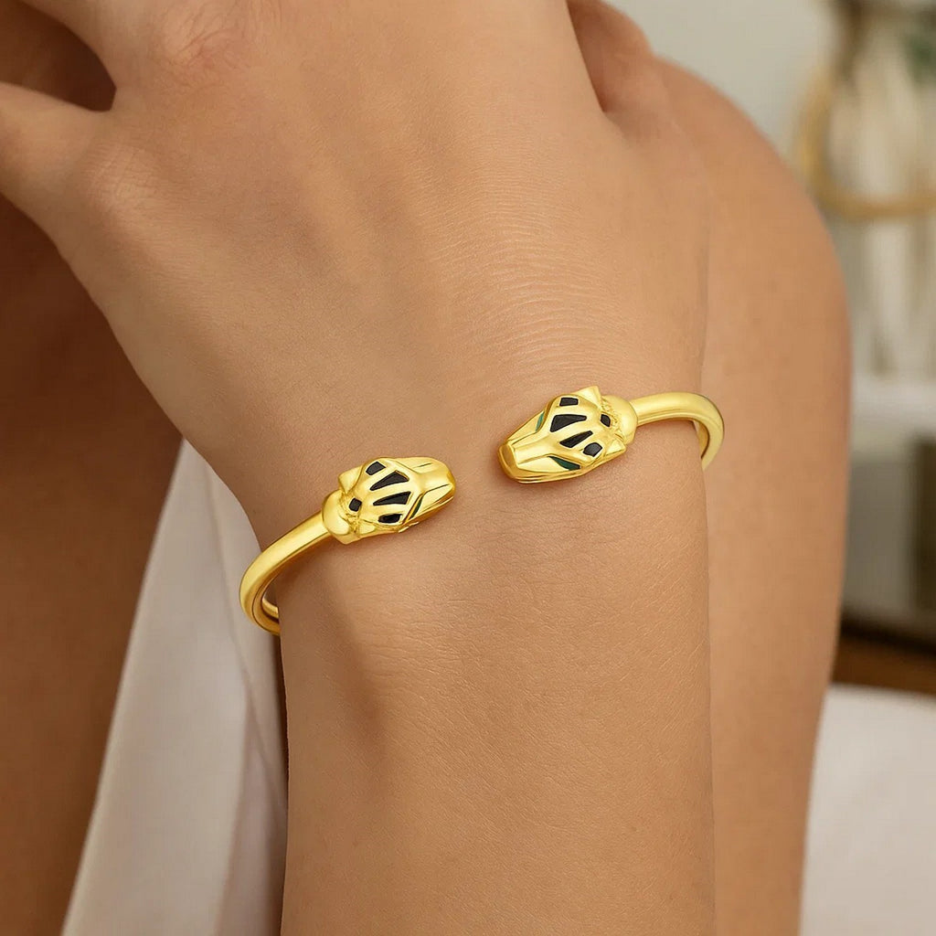 Panther head cuff in 14K yellow gold worn on the wrist