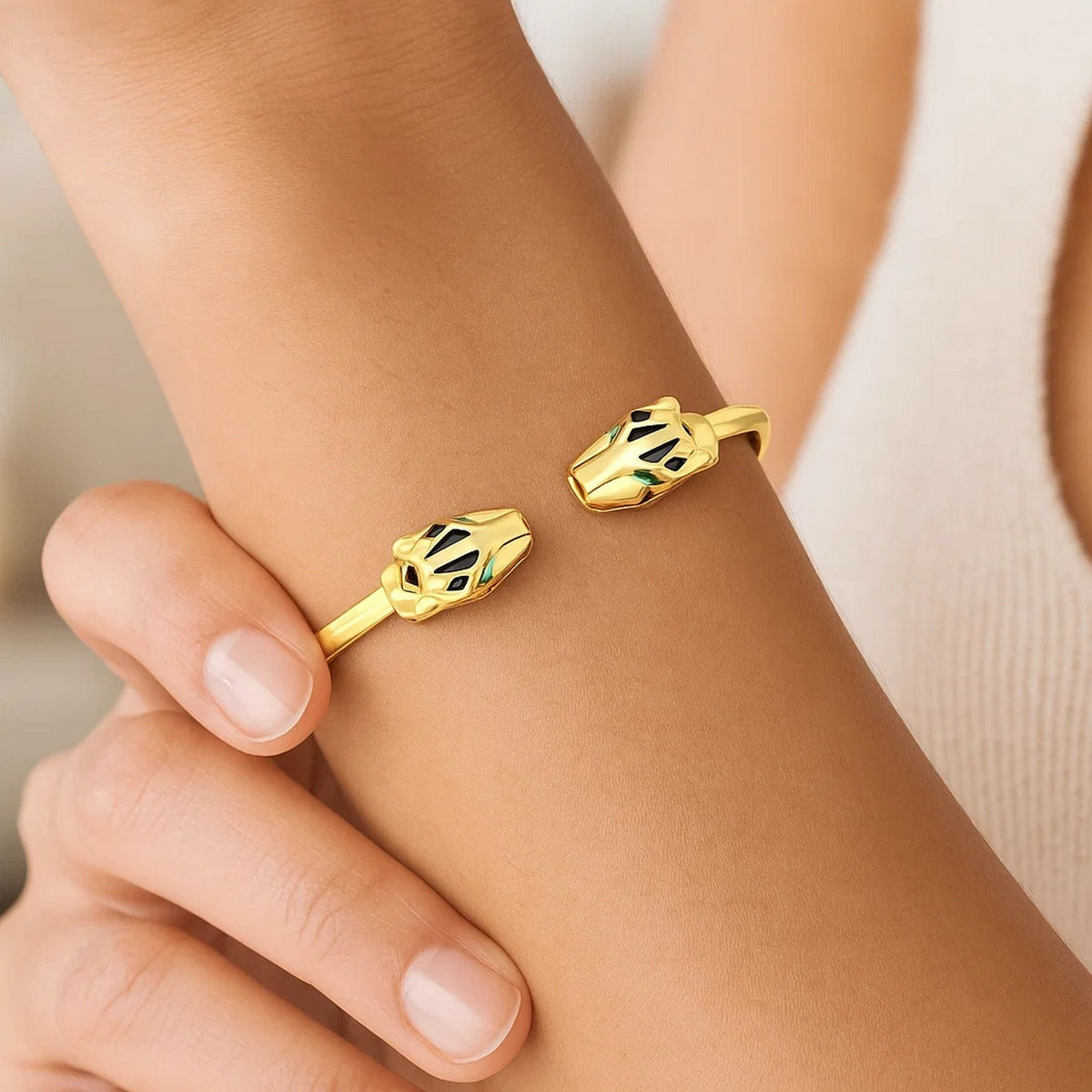 Close view of the 14K yellow gold panther cuff on the arm